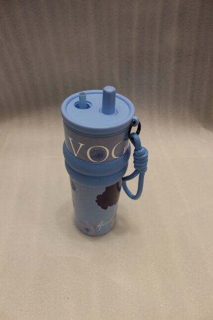 Three 710ml One More VOGUE aesthetic water bottles in pastel blue, cream, and pink featuring straw lids, carrying straps, and floral prints on a kitchen counter.