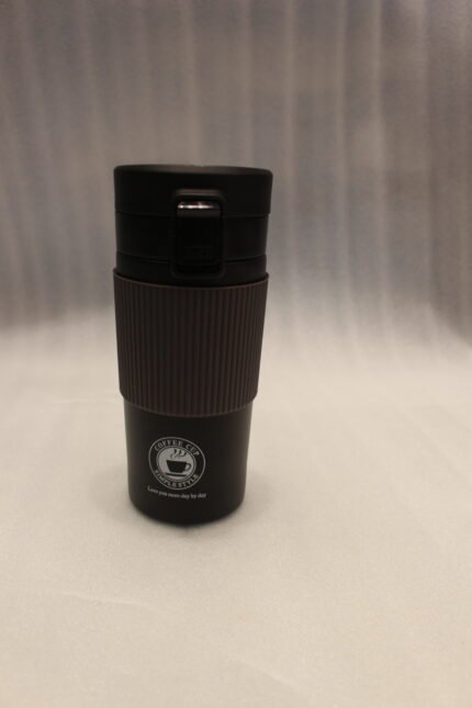 Four 350ml insulated travel coffee mugs in black, beige, olive green, and grey on a kitchen countertop next to coffee beans.