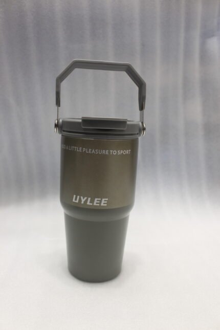 Four UYLEE 600ml stainless steel insulated travel tumblers with folding handles shown in beige, matte black, champagne gold, and olive green on a marble countertop.