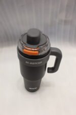 Two HI-HOTCUP 1250ml stainless steel insulated tumblers with handles in silver-cream and matte black on a kitchen counter.
