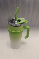 Five 1180ml ombre stainless steel tumblers with handles and straws in blue, green, purple, black, and pink lined up on a marble kitchen counter.