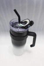 Five 1180ml ombre stainless steel tumblers with handles and straws in blue, green, purple, black, and pink lined up on a marble kitchen counter.