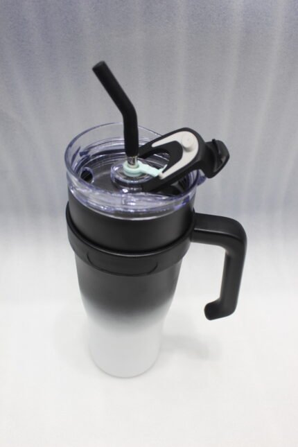 Five 1180ml ombre stainless steel tumblers with handles and straws in blue, green, purple, black, and pink lined up on a marble kitchen counter.