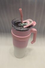 Five 1180ml ombre stainless steel tumblers with handles and straws in blue, green, purple, black, and pink lined up on a marble kitchen counter.