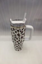 Six 1180ml leopard print insulated travel tumblers with handles and straws displayed in various colors on a kitchen counter.