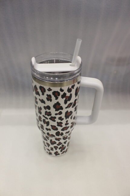 Six 1180ml leopard print insulated travel tumblers with handles and straws displayed in various colors on a kitchen counter.