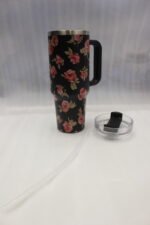 Four 1180ml floral printed insulated tumblers with handles and reusable straws standing on a kitchen counter.