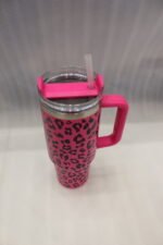 Six 1180ml leopard print insulated travel tumblers with handles and straws displayed in various colors on a kitchen counter.