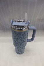 Six 1180ml leopard print insulated travel tumblers with handles and straws displayed in various colors on a kitchen counter.