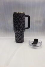 Six 1180ml leopard print insulated travel tumblers with handles and straws displayed in various colors on a kitchen counter.