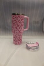 Six 1180ml leopard print insulated travel tumblers with handles and straws displayed in various colors on a kitchen counter.
