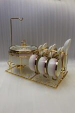Pink and white gradient ceramic soup tureen set with gold rims, suspended glass lid on a gold frame, buffet burner warmer stand, matching soup cups, saucers, and ceramic spoons.