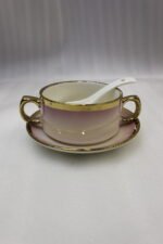 Pink and white gradient ceramic soup tureen set with gold rims, suspended glass lid on a gold frame, buffet burner warmer stand, matching soup cups, saucers, and ceramic spoons.
