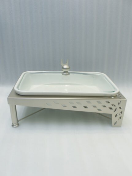 Three rectangular ceramic single buffet dishes with clear glass lids set in champagne gold stands on a kitchen marble countertop.