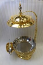 Luxury gold buffet chafing dish with overhead hanging dome lid, stainless steel food pan, and attached serving tongs.