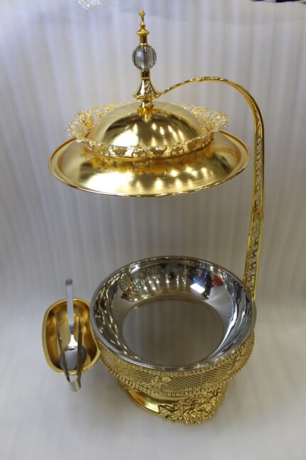 Luxury gold buffet chafing dish with overhead hanging dome lid, stainless steel food pan, and attached serving tongs.