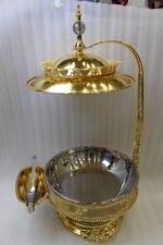 Luxury gold buffet chafing dish with overhead hanging dome lid, stainless steel food pan, and attached serving tongs.