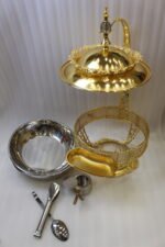 Luxury gold buffet chafing dish with overhead hanging dome lid, stainless steel food pan, and attached serving tongs.