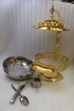 Luxury gold buffet chafing dish with overhead hanging dome lid, stainless steel food pan, and attached serving tongs.