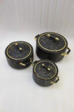 3-piece black marble insulated hot pot casserole set with gold handles on a white marble countertop