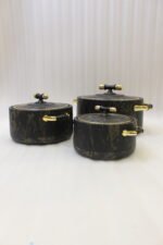 3-piece black marble insulated hot pot casserole set with gold handles on a white marble countertop