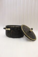 3-piece black marble insulated hot pot casserole set with gold handles on a white marble countertop