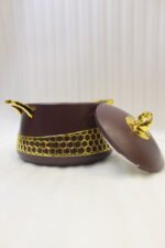 Set of three deep maroon insulated hot pots with gold handles and honeycomb gold accent trim on a kitchen counter.