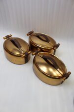 3-piece luxury brushed gold oval insulated hot pot set with leather accent handles displayed on a wooden dining table
