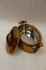 3-piece luxury brushed gold oval insulated hot pot set with leather accent handles displayed on a wooden dining table