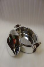 Set of three One More polished stainless steel oval hot pots with brown leather handles in 2L, 2.5L, and 3L sizes on a wooden tabletop.