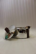Set of three One More polished stainless steel oval hot pots with brown leather handles in 2L, 2.5L, and 3L sizes on a wooden tabletop.