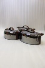One More 3-piece gunmetal stainless steel insulated hot pot set with wood-grain handles on a wooden table.