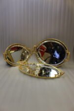 Set of three silver mirrored oval serving trays with floral etchings and textured gold handles on a marble countertop.
