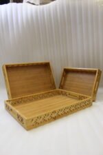 Set of 3 ONEMORE natural wood serving trays with carved geometric side patterns and built-in handles on a marble countertop