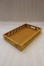 Set of 3 ONEMORE natural wood serving trays with carved geometric side patterns and built-in handles on a marble countertop