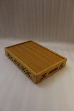 Set of 3 ONEMORE natural wood serving trays with carved geometric side patterns and built-in handles on a marble countertop