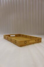 Three-piece natural wooden serving tray set with decorative floral side cutouts displayed on a marble kitchen counter.