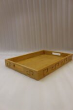 3 piece natural wooden serving tray set with cut-out side handles and engraved geometric border design displayed on a marble kitchen counter