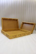Set of 3 natural wooden serving trays with side cutout designs and built-in handles on a marble kitchen countertop