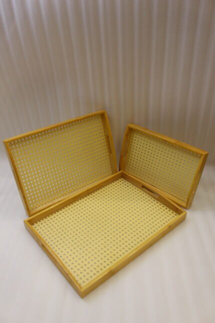 3 piece natural wooden serving tray set with woven cane rattan mesh bottom and side handles on a kitchen countertop