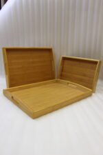 3 piece rectangular wooden serving tray set with built-in cutout handles displayed on a marble kitchen countertop