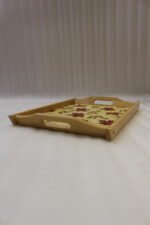 Set of three rectangular wooden serving trays featuring a red maple leaf and berry print displayed on a light kitchen countertop.
