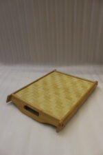 Set of three rectangular wooden serving trays featuring a red maple leaf and berry print displayed on a light kitchen countertop.