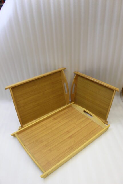 3 piece natural bamboo wooden serving tray set with cut-out side handles on a marble kitchen countertop