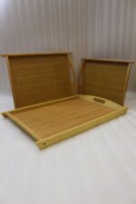 3 piece natural bamboo wooden serving tray set with cut-out side handles on a marble kitchen countertop