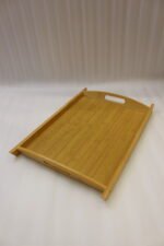 3 piece natural bamboo wooden serving tray set with cut-out side handles on a marble kitchen countertop