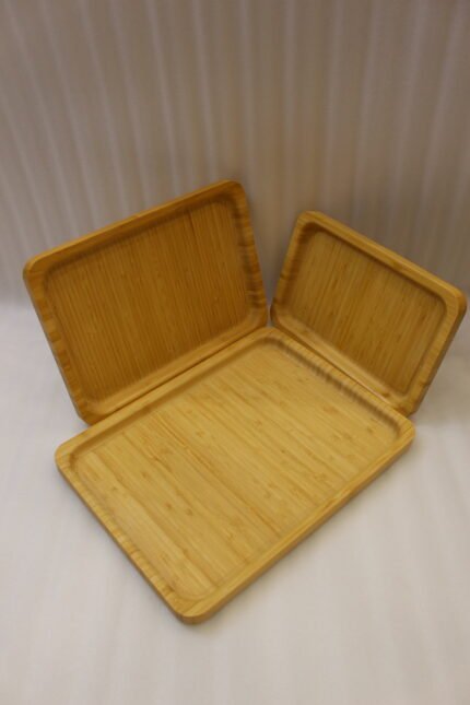 3 piece natural wooden serving tray set with rounded edges in small medium and large sizes on a kitchen counter