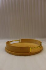 Set of 3 nesting round bamboo wooden serving trays with stylish gold metal handles on a white countertop.