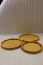 3-piece nested round wooden serving tray set made of natural bamboo displayed on a marble kitchen countertop