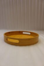 4-piece round wooden nesting serving tray set with built-in cut-out handles stacked on a white kitchen countertop